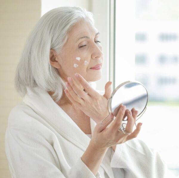 Mature woman applying Scenturie Ultra-rich natural night cream