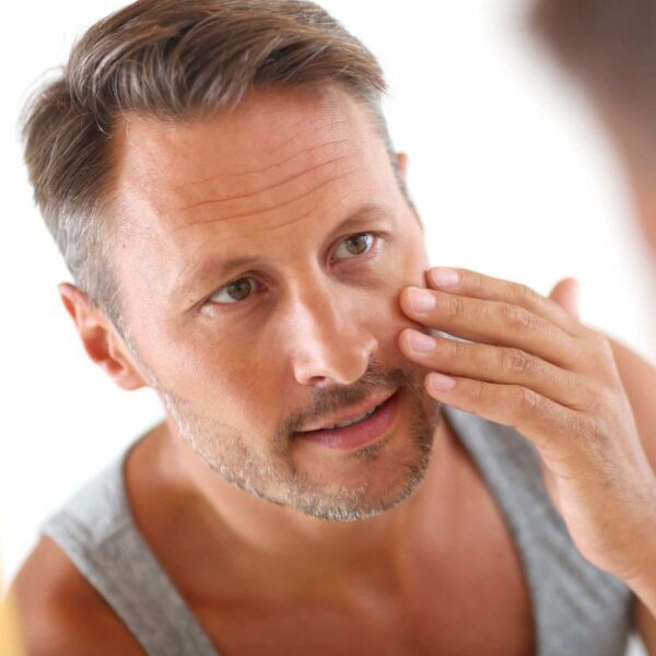 Man applying Scenturie Enhancing Facial Moisturiser