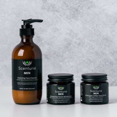 Scenturie's award-winning Men's natural skincare range featuring the Hydrating Face Cleanser, Enhancing Facial Moisturiser, and Charcoal Coffee Face Scrub in amber glass.