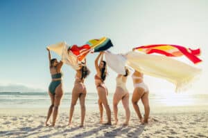 ladies on beach in bikinis