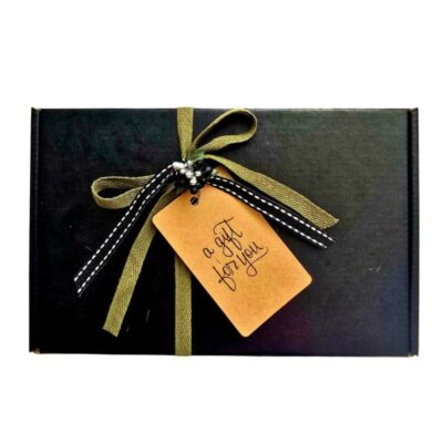 Bespoke Scenturie gift box featuring a hand-written gift tag, signature black matte finish, and sustainable wood wool filling. Personalised natural skincare gifting with free NZ shipping over $99.