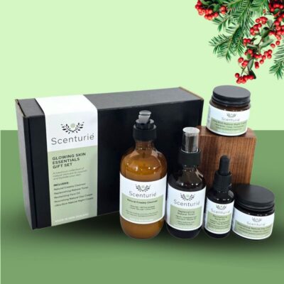 Scenturie's Glowing Skin Essentials Gift Set, showing the 5 full-sized products in a premium, festive-themed Christmas gift box.