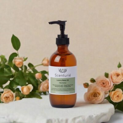 Scenturie's Harmony Body Oil, styled in a peaceful setting with apricot coloured roses.