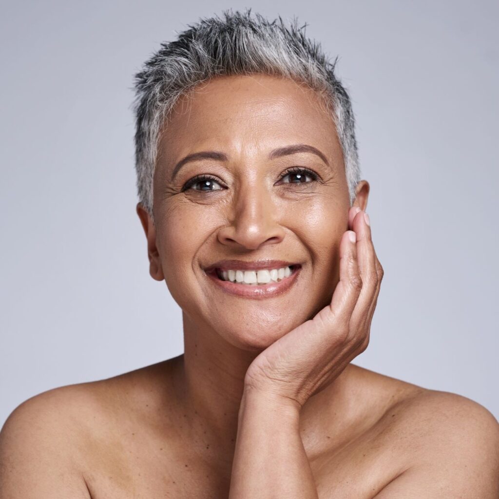 A confident middle-aged woman with radiant, healthy-looking skin, demonstrating the benefits of Scenturie's natural skincare for maturing skin.