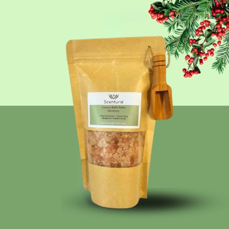 Scenturie Luxury Bath Salts in an eco-friendly paper bag, styled on a green festive background with mistletoe for Christmas