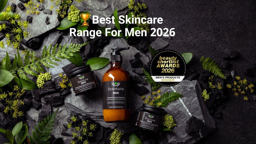 Scenturie MEN natural skincare range including Hydrating Face Cleanser, Charcoal Coffee Scrub, and Facial Moisturiser in amber glass. Set against a dark background with native NZ foliage and the International Beauty Shortlist Awards 2026 Gold Winner logo. Winner of 6 major awards.