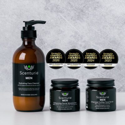 Scenturie MEN award-winning range featuring the Hydrating Face Cleanser, Enhancing Facial Moisturiser, and Charcoal Coffee Face Scrub in amber glass. Displaying four International Beauty Shortlist Award seals for 2023, 2024, 2025, and 2026. 4-year winning men's routine.