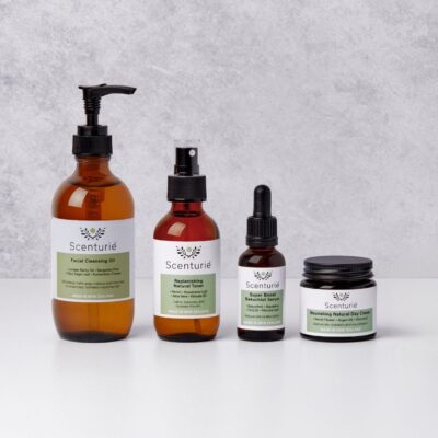 Four amber glass bottles of Scenturie's Balancing Natural Skincare Set for oily and combination skin, featuring the cleansing oil, toner, Bakuchiol serum, and day cream.