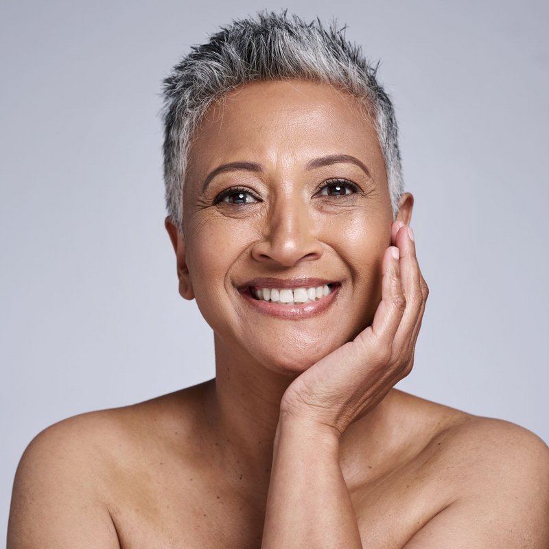 Smiling woman in her 60's with healthy mature skin