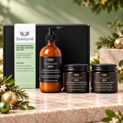 Scenturie MEN Natural Skincare Gift Set featuring hydrating face cleanser, enhancing facial moisturiser and charcoal coffee face scrub, styled with festive greenery, gold ornaments and warm Christmas lights.
